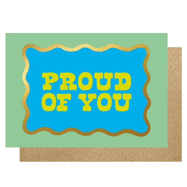 Card with 'PROUD OF YOU' text on a blue background with gold border, on a green card with brown envelope.