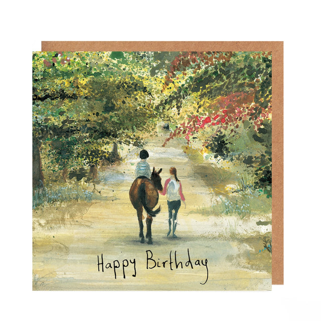 Birthday card with illustration of two people walking a donkey through a scenic path.