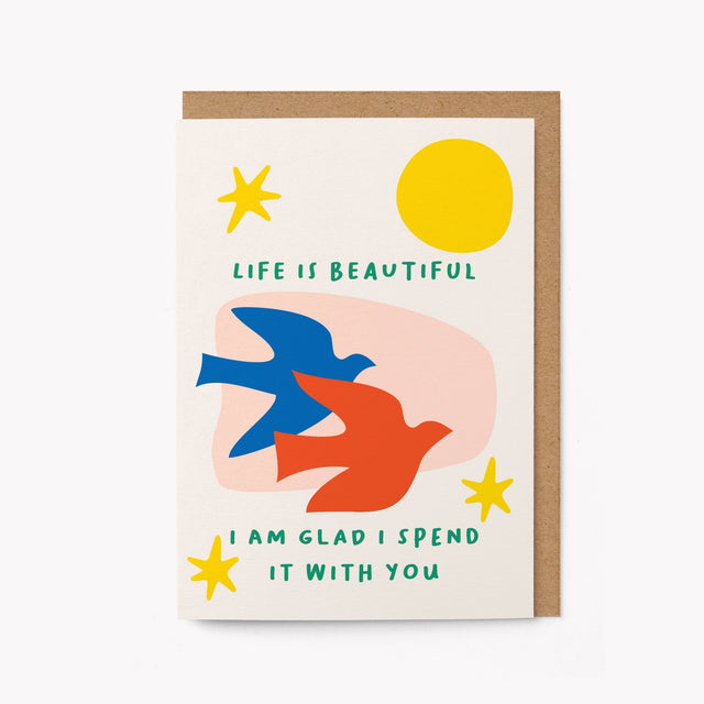 Greeting card with colorful birds, sun, and stars on a white background