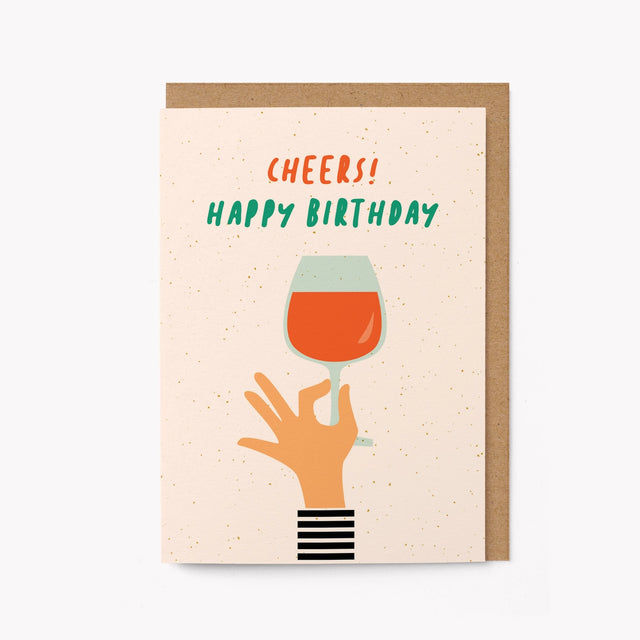 Birthday card with a hand holding a wine glass and 'Cheers! Happy Birthday' text on a beige background.