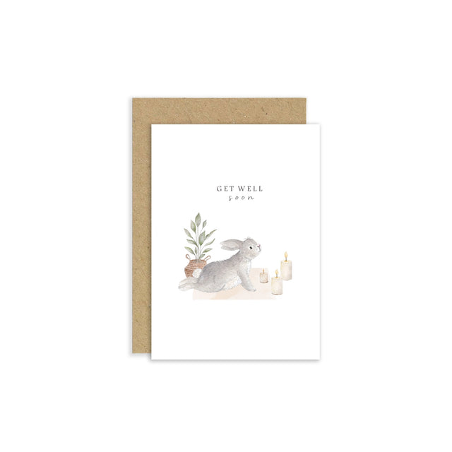 Greeting card with a rabbit illustration and 'Get Well Soon' text, featuring a brown envelope on a white background.