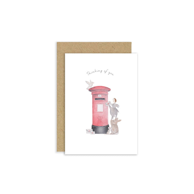 Greeting card with a pink postbox illustration and text 'Thinking of you' on a white background.