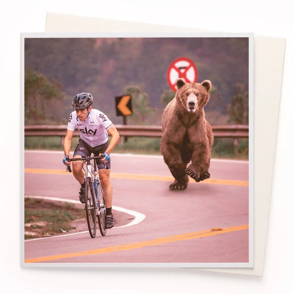 bear-chasing-cyclist-1000-words-greeting-card-ustudio